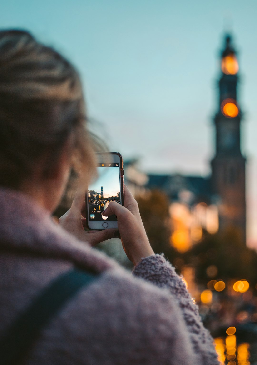 woman-taking-photo-of-a-building-during-daytime-smzmtha7dqg